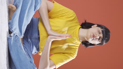 Vertical-video-of-The-meditating-young-woman.